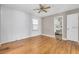 Bedroom featuring light hardwood floors, a ceiling fan, neutral paint, and an attached bathroom at 728 N Summerlin Ave, Orlando, FL 32803