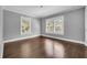 Bedroom with hardwood floors and natural light streaming through two large windows at 728 N Summerlin Ave, Orlando, FL 32803