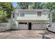 Rear elevation view with garage, exterior stairwell, and a partial view of the backyard at 728 N Summerlin Ave, Orlando, FL 32803