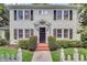 Charming two-story home featuring shake siding, black shutters, and neatly manicured landscaping at 728 N Summerlin Ave, Orlando, FL 32803