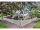 Charming two-story home featuring manicured landscaping and a classic white picket fence at 728 N Summerlin Ave, Orlando, FL 32803