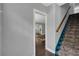 Hallway view with a staircase and a glimpse into the sunlit living room at 728 N Summerlin Ave, Orlando, FL 32803