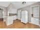 Compact kitchen featuring a breakfast bar, white appliances, and hardwood floors at 728 N Summerlin Ave, Orlando, FL 32803