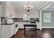 Bright kitchen with white cabinets, black countertops, and stainless steel appliances at 728 N Summerlin Ave, Orlando, FL 32803