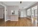 Living room with hardwood floors adjacent to a kitchen and sunroom at 728 N Summerlin Ave, Orlando, FL 32803