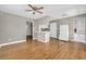 Living room with hardwood floors adjacent to a kitchen with breakfast bar and white appliances at 728 N Summerlin Ave, Orlando, FL 32803