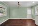 Charming living room featuring hardwood floors, a laundry area, and natural light at 728 N Summerlin Ave, Orlando, FL 32803