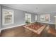 Bright living room featuring hardwood floors, a colorful rug, and natural light from the large window at 728 N Summerlin Ave, Orlando, FL 32803