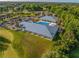 Overhead shot highlighting the pool, surrounding buildings, and golf course at 7296 Sw 115Th Pl, Ocala, FL 34476