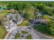 An aerial view of the clubhouse, golf carts, and outdoor patio area at 7296 Sw 115Th Pl, Ocala, FL 34476