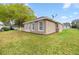 Lawn view showcasing the house exterior with a well-maintained lawn, windows, and stucco at 7296 Sw 115Th Pl, Ocala, FL 34476