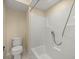 Clean, neutral-toned bathroom with a shower and a white toilet, providing a functional space at 7296 Sw 115Th Pl, Ocala, FL 34476