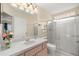 Bathroom featuring a glass enclosed shower, a large mirror, and a single vanity sink at 7296 Sw 115Th Pl, Ocala, FL 34476