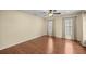 Spacious bedroom with a ceiling fan, neutral walls, and wood-look laminate flooring at 7296 Sw 115Th Pl, Ocala, FL 34476