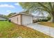 Exterior shot showing a two-car garage with a concrete driveway and green lawn at 7296 Sw 115Th Pl, Ocala, FL 34476