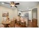 Well-lit eat-in kitchen featuring white cabinets, stainless steel appliances, and an open layout to the dining room at 7296 Sw 115Th Pl, Ocala, FL 34476