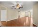 Spacious living room featuring wood flooring, neutral paint, and multiple ceiling fans for optimal comfort at 7296 Sw 115Th Pl, Ocala, FL 34476