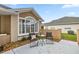 This patio has neutral tones, an attractive window, and comfortable outdoor seating at 7296 Sw 115Th Pl, Ocala, FL 34476