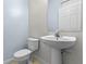 Bright half bathroom with a pedestal sink and modern fixtures at 7614 Acklins Rd, Kissimmee, FL 34747