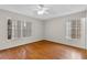 Cozy bedroom with wood floors and natural light from the windows at 7614 Acklins Rd, Kissimmee, FL 34747