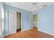 Bedroom featuring hardwood floors, a ceiling fan, and an open closet at 7614 Acklins Rd, Kissimmee, FL 34747