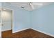 Comfortable bedroom with wood flooring, ceiling fan, and neutral paint at 7614 Acklins Rd, Kissimmee, FL 34747