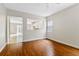 Open living room with wood-look floors and a clear view of the bright kitchen at 7614 Acklins Rd, Kissimmee, FL 34747