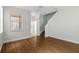 Inviting living room with wood-look floors and staircase, bathed in natural light at 7614 Acklins Rd, Kissimmee, FL 34747