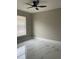 Bright bedroom features large window and a modern ceiling fan and the tile floor is marble patterned at 7727 Harbor Lake Dr, Orlando, FL 32822