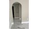 Hallway features unique archways and marble patterned tile floor with neutral colored walls at 7727 Harbor Lake Dr, Orlando, FL 32822