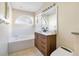 Well-lit bathroom features a modern vanity, soaking tub, and stylish fixtures at 8076 Aspencrest Ct, Orlando, FL 32835