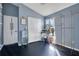 Bedroom with blue walls, dark floors, closet, and vanity at 8076 Aspencrest Ct, Orlando, FL 32835