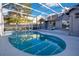 Relaxing screened-in pool with spa and sunny sky at 8076 Aspencrest Ct, Orlando, FL 32835