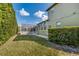 Backyard view showcases the home's well-maintained lawn, mature shrubs, and the screened-in pool enclosure at 824 Preserve Ter, Lake Mary, FL 32746