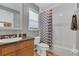 Well-lit bathroom with a vanity and a shower tub featuring stylish curtain and tiled floor at 824 Preserve Ter, Lake Mary, FL 32746