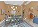 Formal dining room with a modern chandelier, neutral walls, and tiled flooring at 824 Preserve Ter, Lake Mary, FL 32746