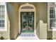 Close-up of the front door with decorative ironwork and sidelight windows at 824 Preserve Ter, Lake Mary, FL 32746