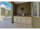 Outdoor kitchen on screened lanai features countertop space and storage cabinets at 824 Preserve Ter, Lake Mary, FL 32746