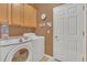 Functional laundry room with front loading appliances and overhead cabinets for storage at 824 Preserve Ter, Lake Mary, FL 32746