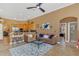 Inviting living room featuring a ceiling fan, a decorative rug, and an open layout to the kitchen at 824 Preserve Ter, Lake Mary, FL 32746