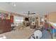 Bright living room featuring a ceiling fan, television, dining table and gaming decor at 824 Preserve Ter, Lake Mary, FL 32746