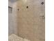 Shower stall featuring stone tile, pebble floor, and a built in shelving unit at 824 Preserve Ter, Lake Mary, FL 32746