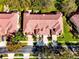 Aerial view showcases the building's red tile roof, neat landscaping, and a driveway with a parked car at 8443 Via Bella Notte, Orlando, FL 32836