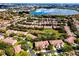 Aerial view displays homes near a scenic lake and water feature, with lush trees enhancing the community's ambiance at 8443 Via Bella Notte, Orlando, FL 32836