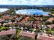 Picturesque aerial view of a lakefront community with beautiful homes and lush trees at 8443 Via Bella Notte, Orlando, FL 32836