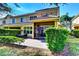 Spacious backyard featuring a patio with seating, a screen enclosure, and beautiful, mature greenery at 8443 Via Bella Notte, Orlando, FL 32836