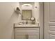 A clean bathroom with a small vanity, countertop sink and a square mirror at 8443 Via Bella Notte, Orlando, FL 32836