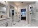 Luxurious bathroom featuring a glass shower, dual sinks with quartz countertops and modern fixtures at 8443 Via Bella Notte, Orlando, FL 32836