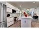 A chef's kitchen with modern stainless steel appliances, white cabinets and granite countertops at 8443 Via Bella Notte, Orlando, FL 32836