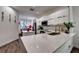 Modern kitchen with white cabinets, stainless steel appliances, large sink and island with quartz countertop at 8443 Via Bella Notte, Orlando, FL 32836